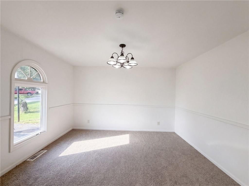 Statement lighting, wainscoting or board and batten and shiplap / paneling at 12904 E 54th Street, Kansas City, MO 64133