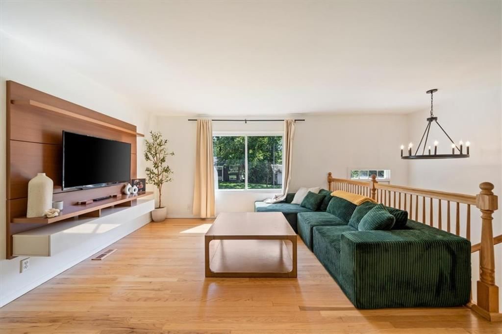 Hardwood floors, statement lighting and wall of windows at 8506 E 91st Street, Kansas City, MO 64138