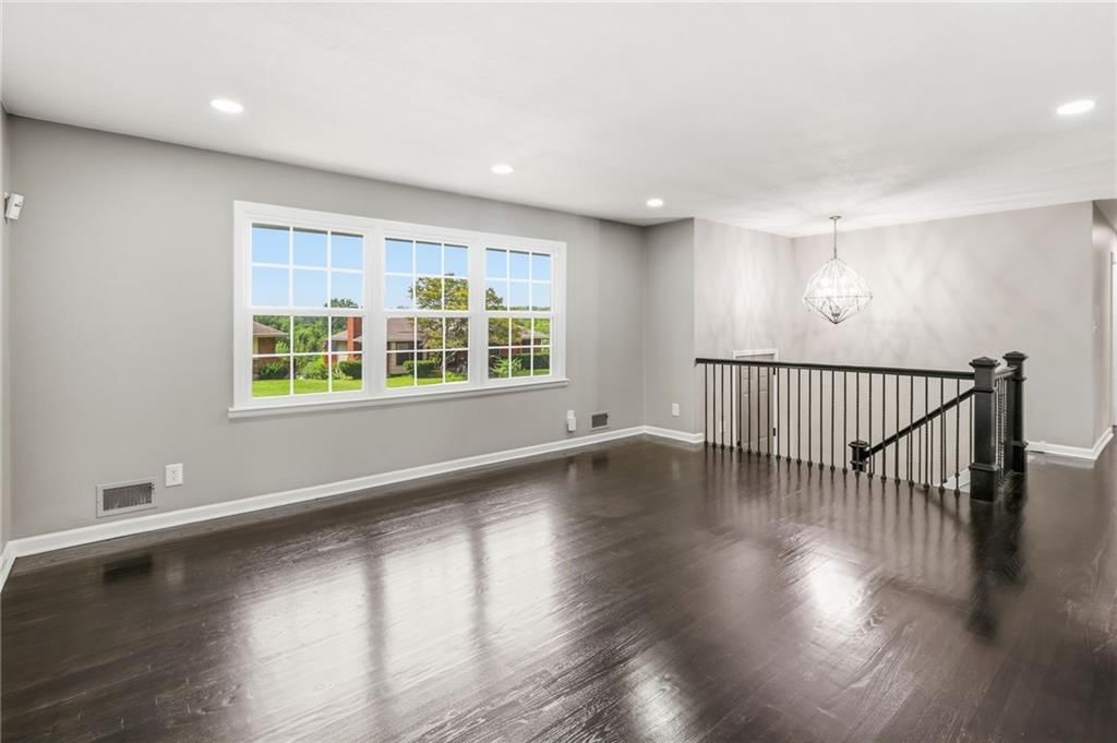 Hardwood floors and wall of windows at 11818 E 62nd Terrace, Kansas City, MO 64133