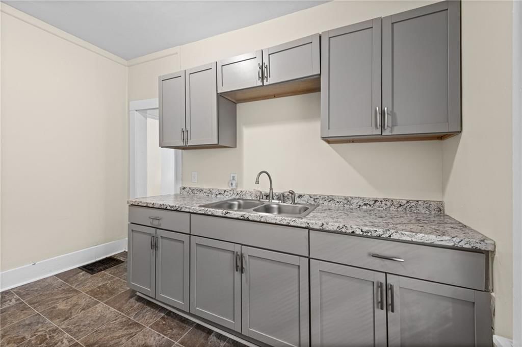 Granite counters, gray kitchen cabinets and shaker cabinets at 743 Kickapoo Street, Leavenworth, KS 66048