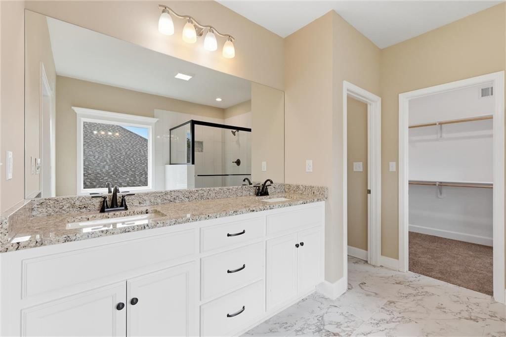 Walk-in shower, tiled shower and frameless glass shower at 7402 Palmer Avenue, Kansas City, MO 64133