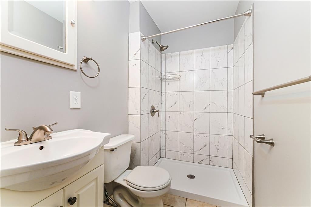 Tiled shower, frameless glass shower and renovated bathrooms at 807 N Ponca Drive, Independence, MO 64056