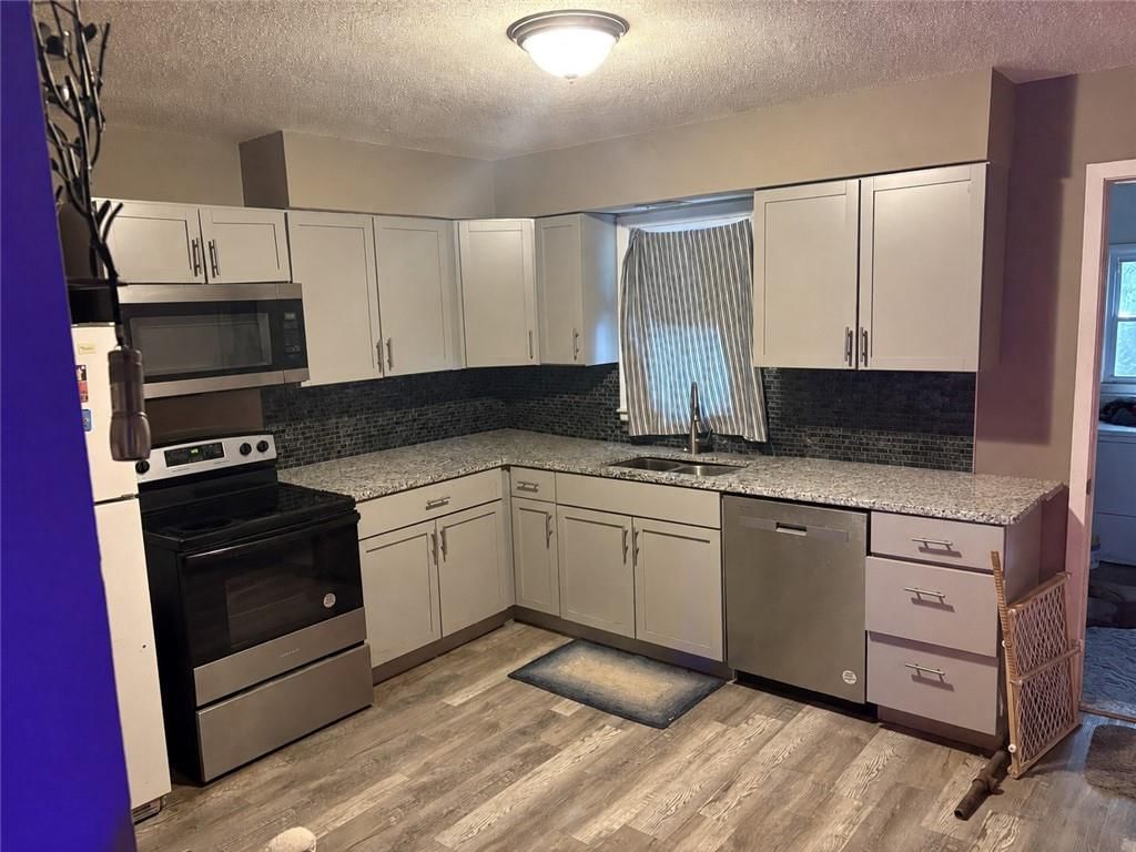 White kitchen cabinets at 205 N Mahaffie Street, Olathe, KS 66061