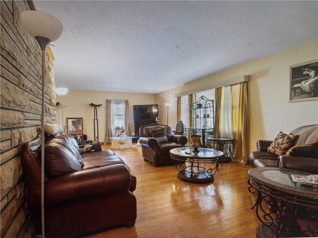 Open floor plan, hardwood floors and wall of windows at 9723 E 13th Street S, Independence, MO 64052