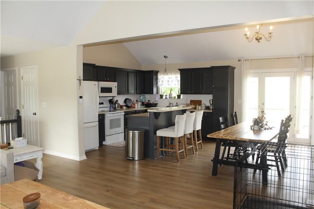 Tall ceilings, open floor plan and kitchen island at 212 E Whispering Hills Boulevard, Lone Jack, MO 64070