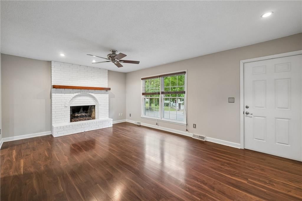 Hardwood floors and wall of windows at 7317 NW 77th Terrace, Kansas City, MO 64152