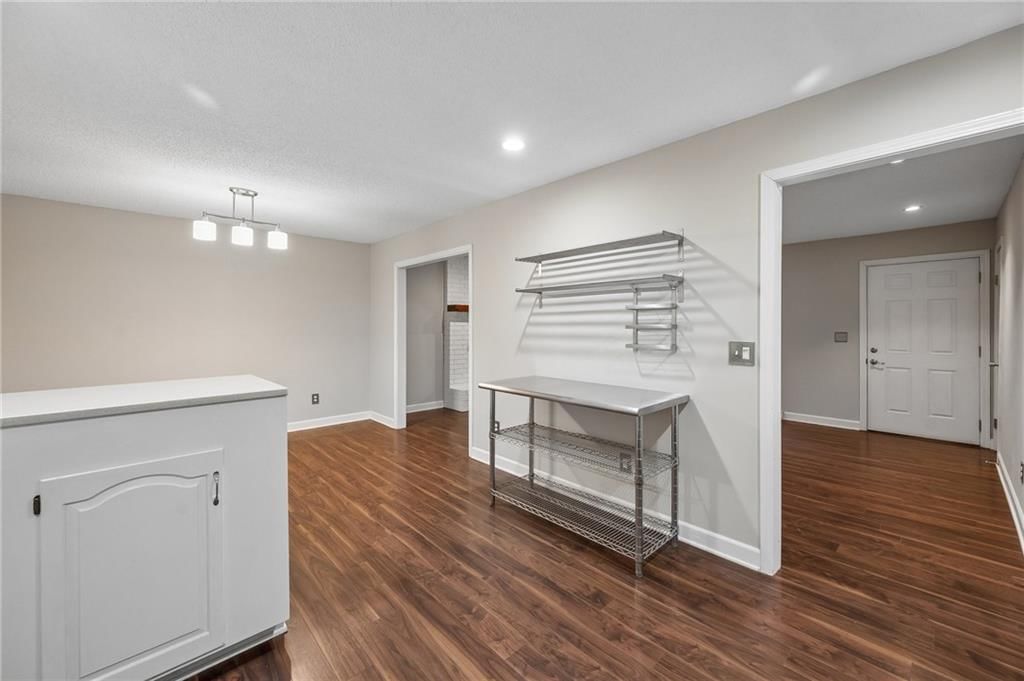 Open floor plan and statement lighting at 7317 NW 77th Terrace, Kansas City, MO 64152