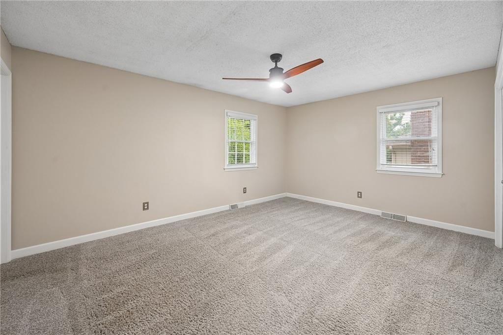 Main-floor primary bedroom at 7317 NW 77th Terrace, Kansas City, MO 64152