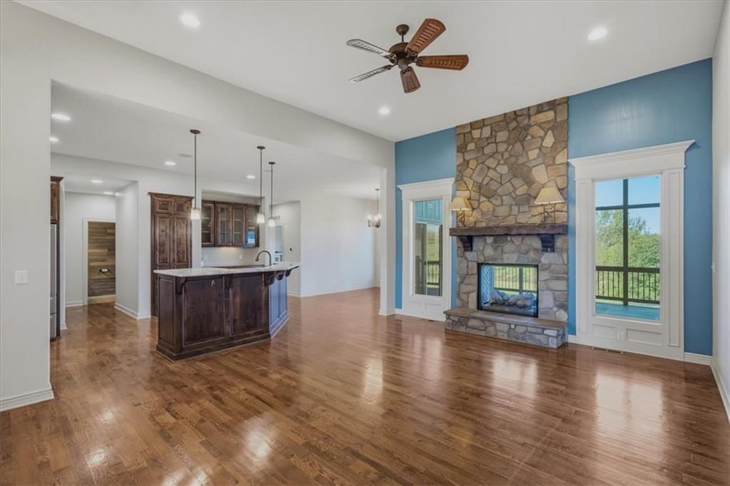 Fireplace, open floor plan and accent wall at 22702 E 41st Terrace, Independence, MO 64015