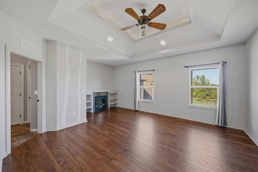 Main-floor primary bedroom, tray ceiling and bedroom sitting area at 22702 E 41st Terrace, Independence, MO 64015