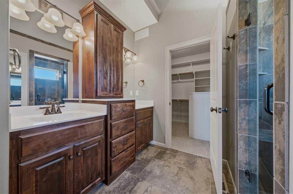 Tile floors and double vanity at 22702 E 41st Terrace, Independence, MO 64015