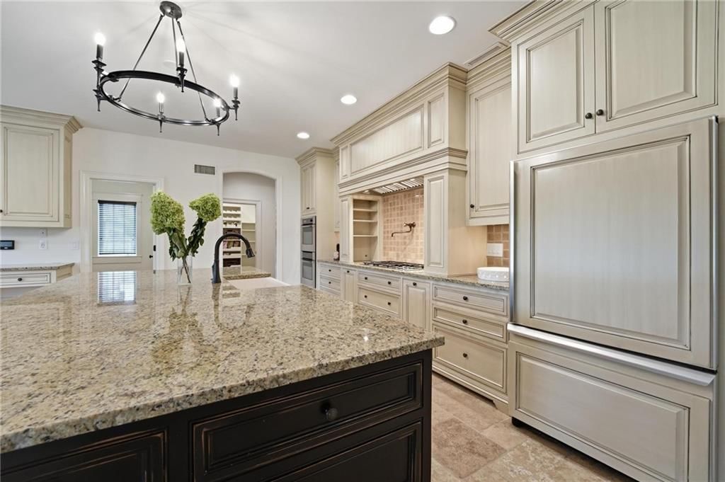Kitchen island, statement lighting and granite counters at 16199 Overbrook Lane, Stilwell, KS 66085