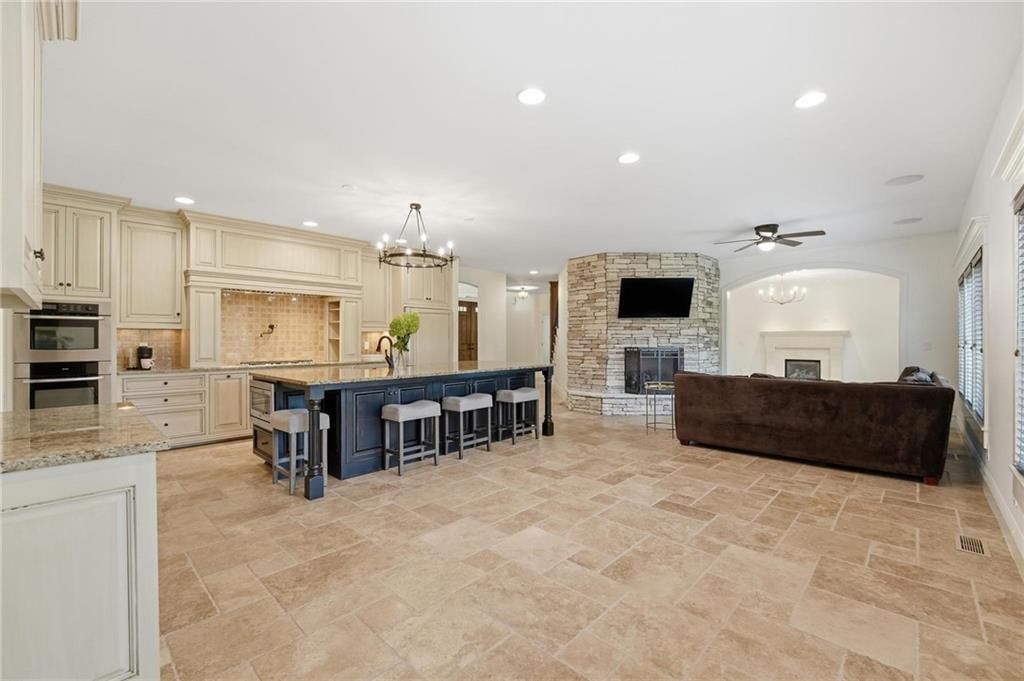Open floor plan and floor-to-ceiling windows at 16199 Overbrook Lane, Stilwell, KS 66085
