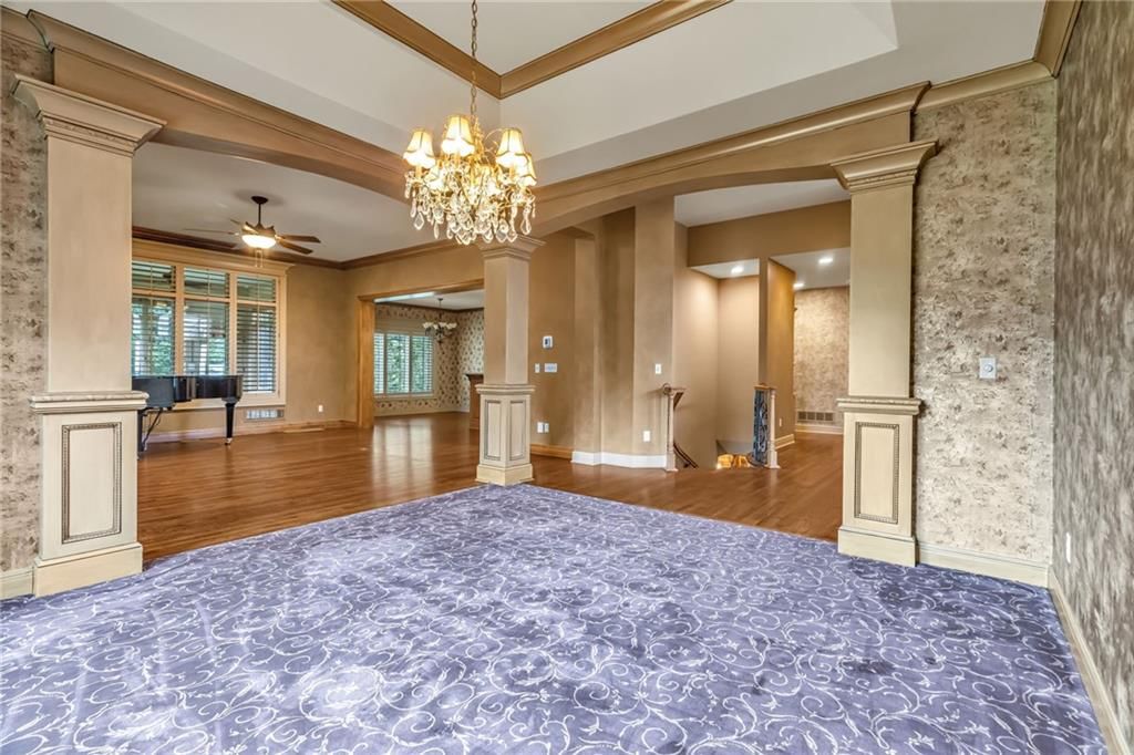 Main-floor primary bedroom and statement lighting at 5303 W 124th Court, Overland Park, KS 66209