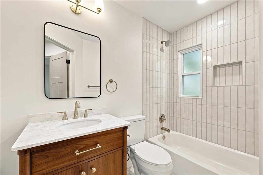 Frameless glass shower, tiled shower and shiplap / paneling at 3331 S Arlington Avenue, Independence, MO 64052