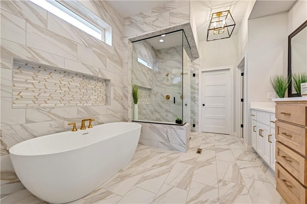 Walk-in shower, freestanding tub and tiled shower at 24980 W 98th Place, Lenexa, KS 66227