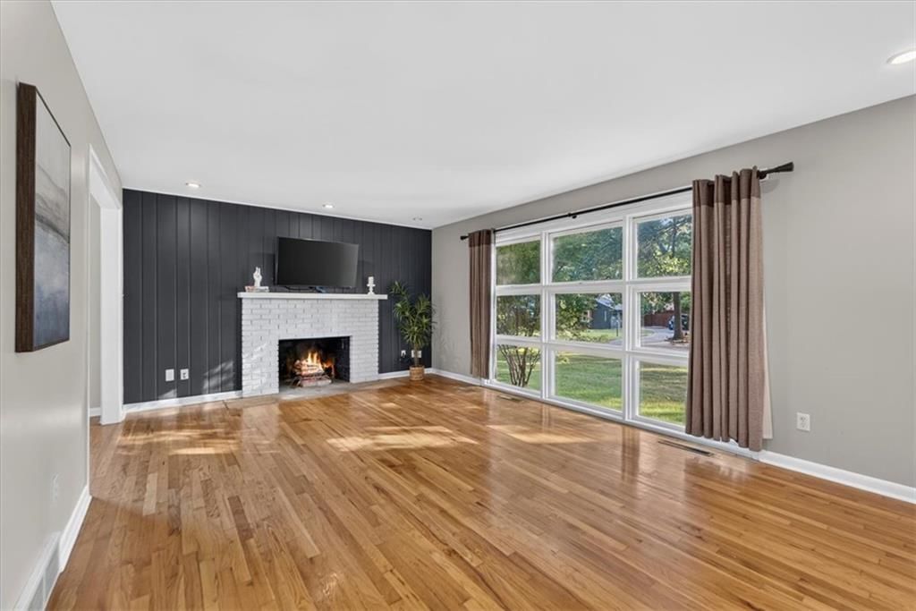 Open floor plan and wall of windows at 6324 Robin Hood Drive, Merriam, KS 66203