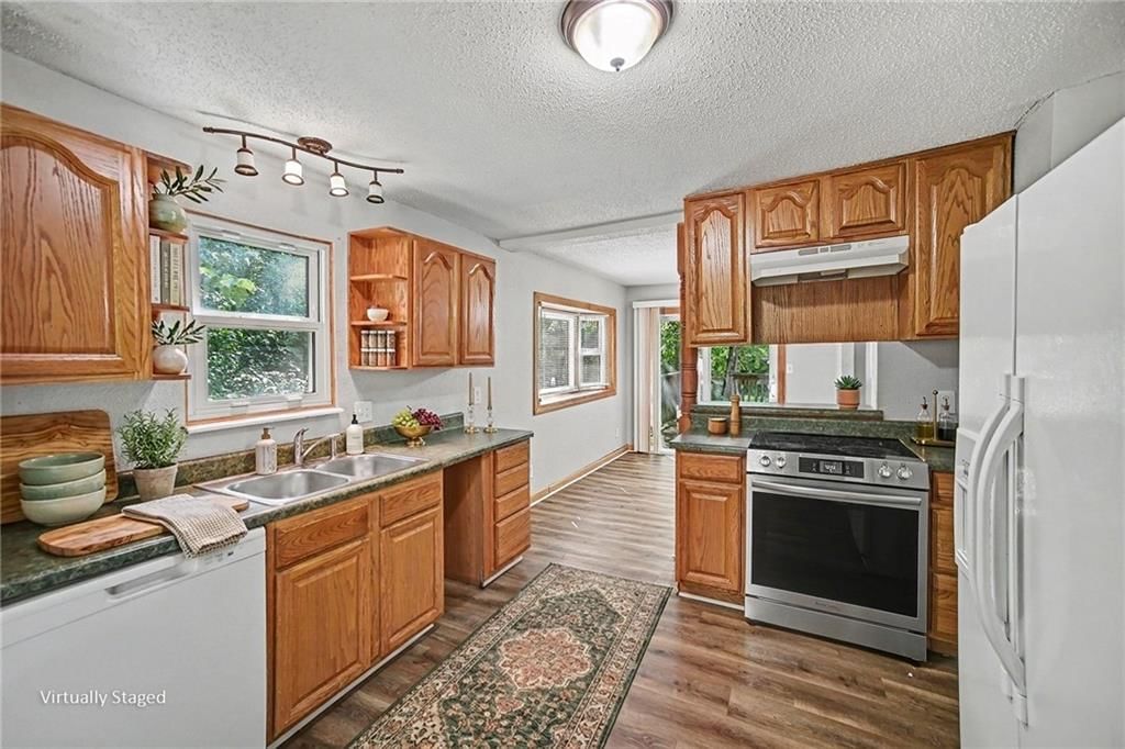 Open floor plan, hardwood floors and granite counters at 9038 Manning Avenue, Kansas City, MO 64138