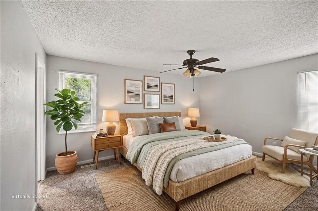 Main-floor primary bedroom and carpet at 9038 Manning Avenue, Kansas City, MO 64138