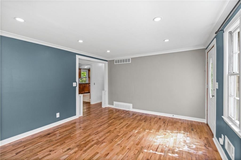 Hardwood floors, wall of windows and recessed lighting at 4516 NW Gleason Road, Kansas City, MO 64151
