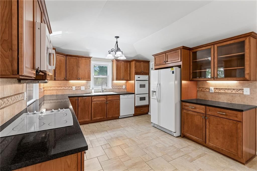 Granite counters, kitchen backsplash and subway tile backsplash at 4516 NW Gleason Road, Kansas City, MO 64151