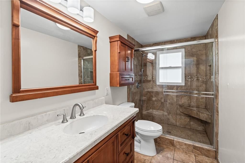 Walk-in shower, tiled shower and double vanity at 4516 NW Gleason Road, Kansas City, MO 64151