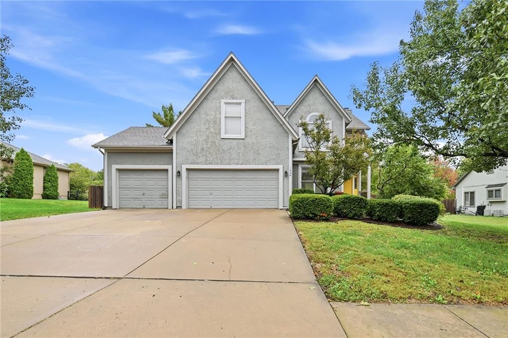 Garage for three or more cars and attached garage at 1404 Cedar Ridge Circle, Raymore, MO 64083