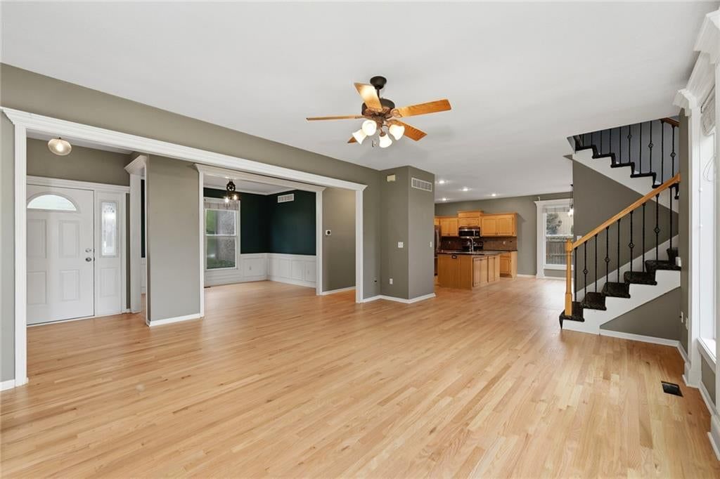Open floor plan and wall of windows at 1404 Cedar Ridge Circle, Raymore, MO 64083