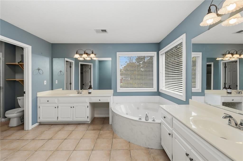 Private toilet room and double vanity at 1404 Cedar Ridge Circle, Raymore, MO 64083