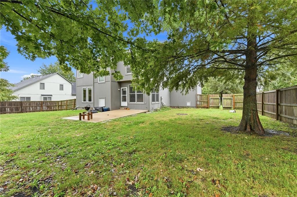Big backyard, fenced yard and mature trees at 1404 Cedar Ridge Circle, Raymore, MO 64083