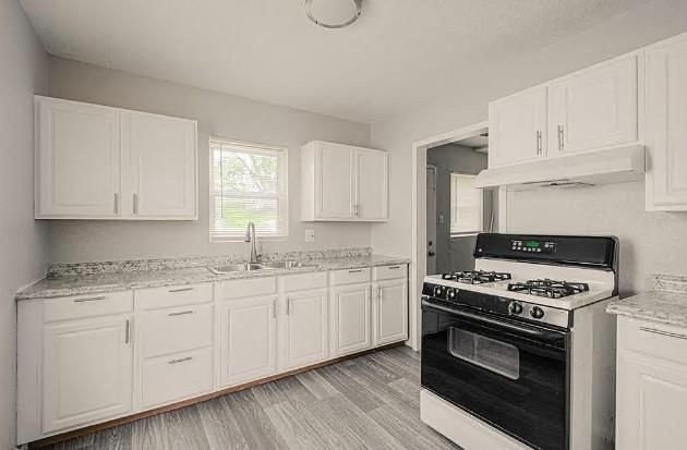 White kitchen, updated kitchen and black appliances at 2105-07 Askew Avenue, Kansas City, MO 64127