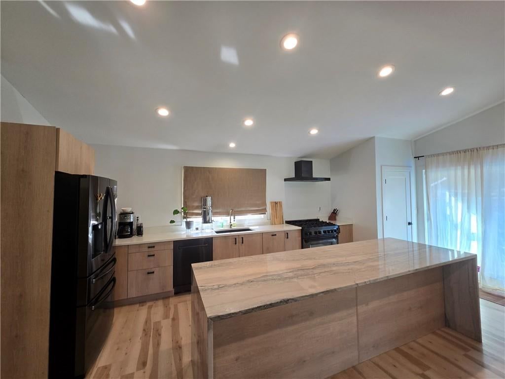 Kitchen island, quartz counters and waterfall island at 7142 FOREST Avenue, Kansas City, MO 64131