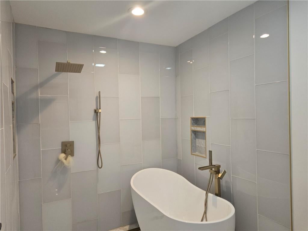 Freestanding tub and frameless glass shower at 7142 FOREST Avenue, Kansas City, MO 64131