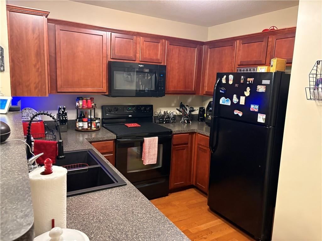 Granite counters, wood kitchen cabinets and electric range at 3628 NW 84th Terrace, Kansas City, MO 64154
