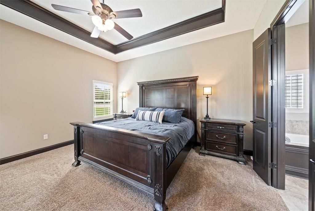 Carpet and main-floor primary bedroom at 3111 N 118TH Terrace, Kansas City, KS 66109