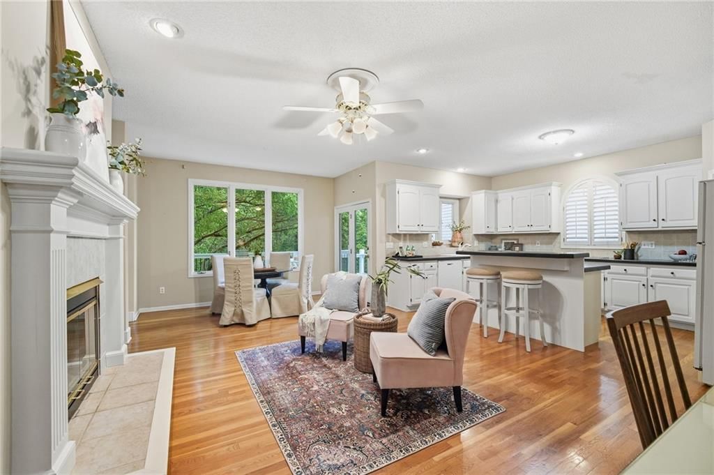 Open floor plan, kitchen island and hardwood floors at 12610 W 126th Street, Overland Park, KS 66213