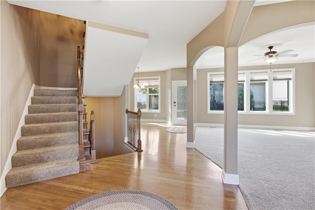 Hardwood floors, staircase and wood stair railing at 11454 S Lakecrest Drive, Olathe, KS 66061