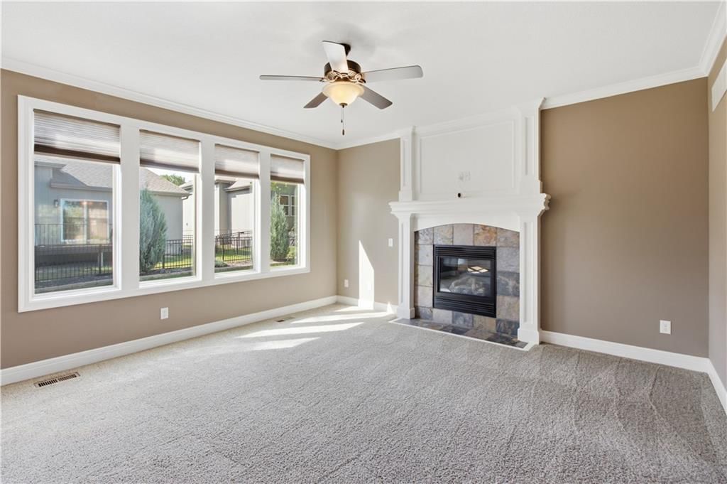 Fireplace and wall of windows at 11454 S Lakecrest Drive, Olathe, KS 66061