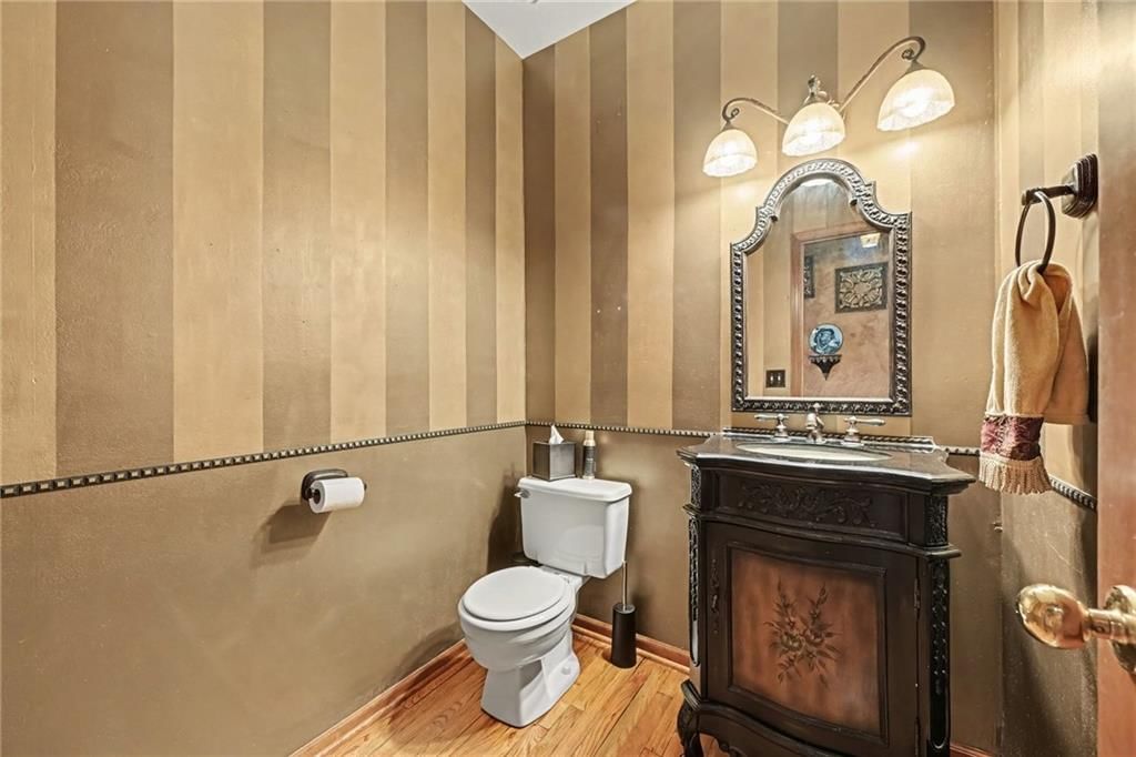 Fireplace and main-floor primary bedroom at 8225 NW Weatherby Drive, Weatherby Lake, MO 64152