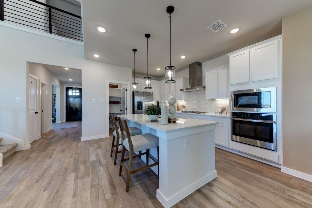 Kitchen island, white kitchen and quartz counters at 17678 Jubilee Street, Gardner, KS 66030