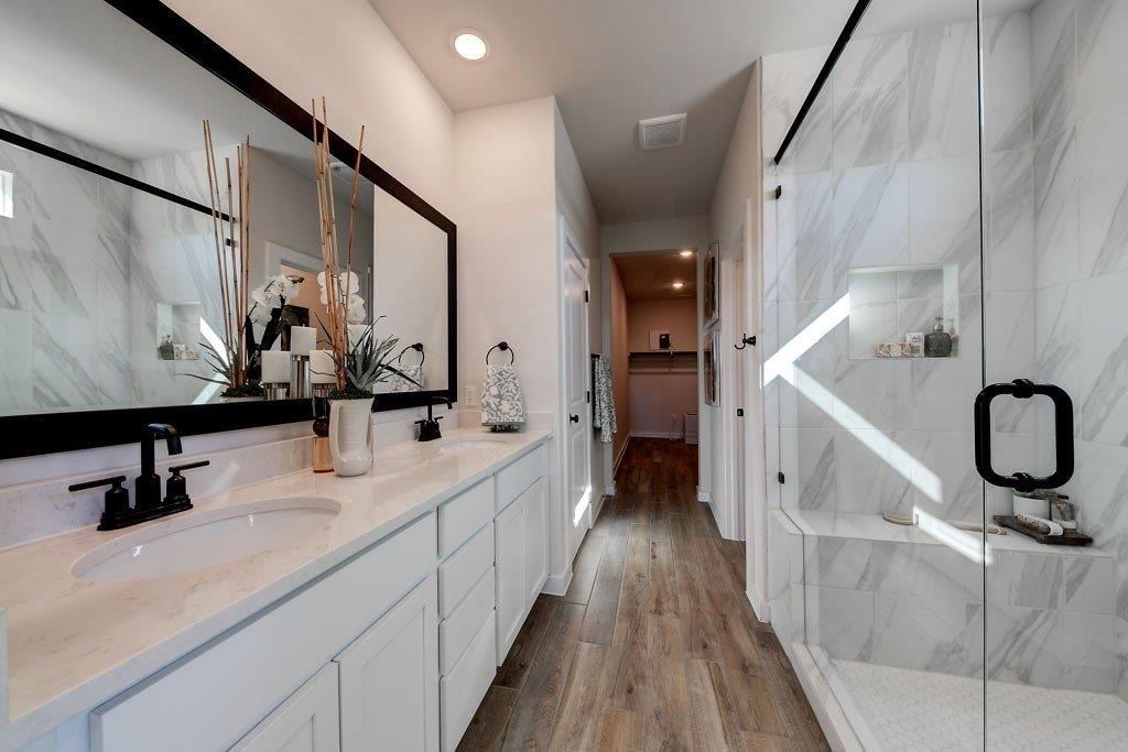 Walk-in shower, tiled shower and double vanity at 17678 Jubilee Street, Gardner, KS 66030