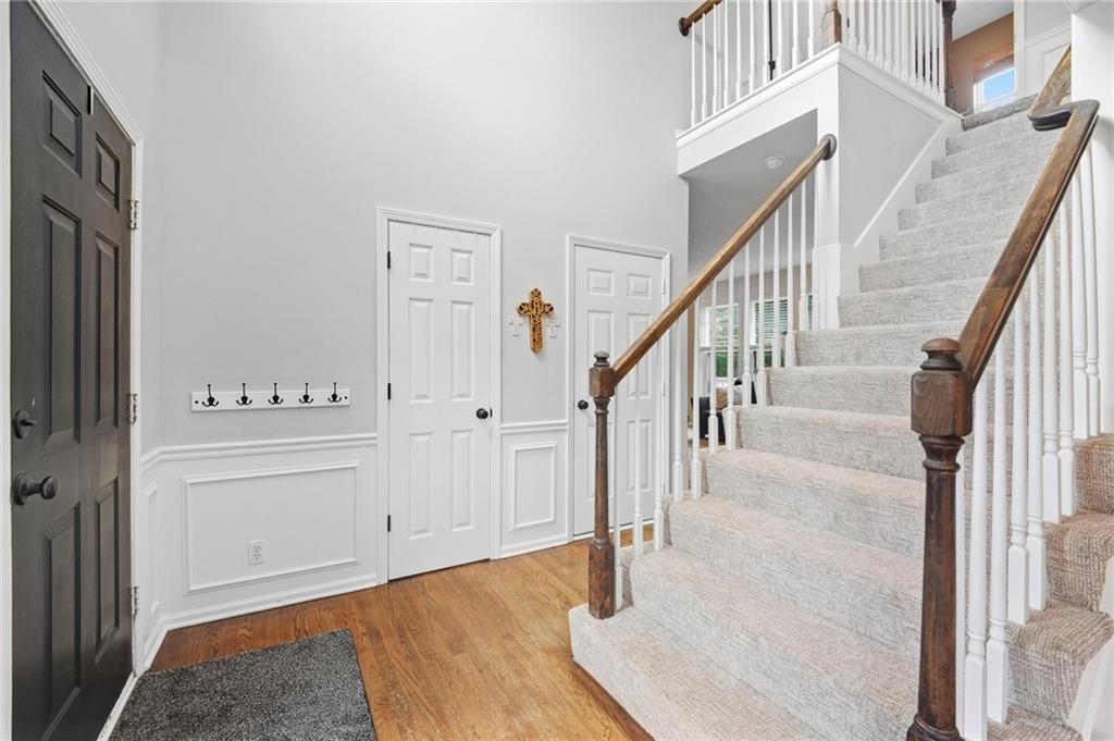 Wainscoting or board and batten, shiplap / paneling and staircase at 16150 W 156th Place, Olathe, KS 66062