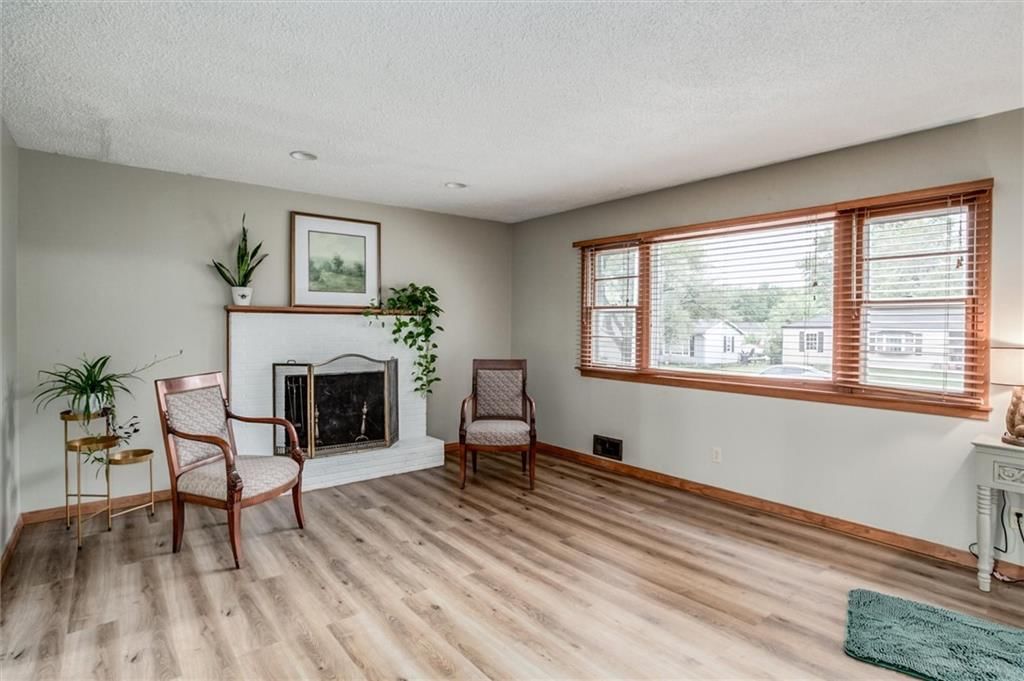 Fireplace, hardwood floors and brick fireplace at 1025 E Elm Street, Olathe, KS 66061