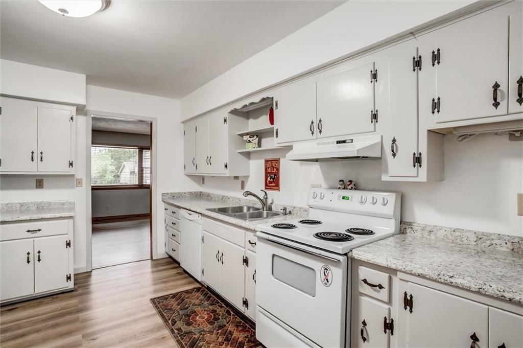 Open floor plan, white kitchen and granite counters at 1025 E Elm Street, Olathe, KS 66061