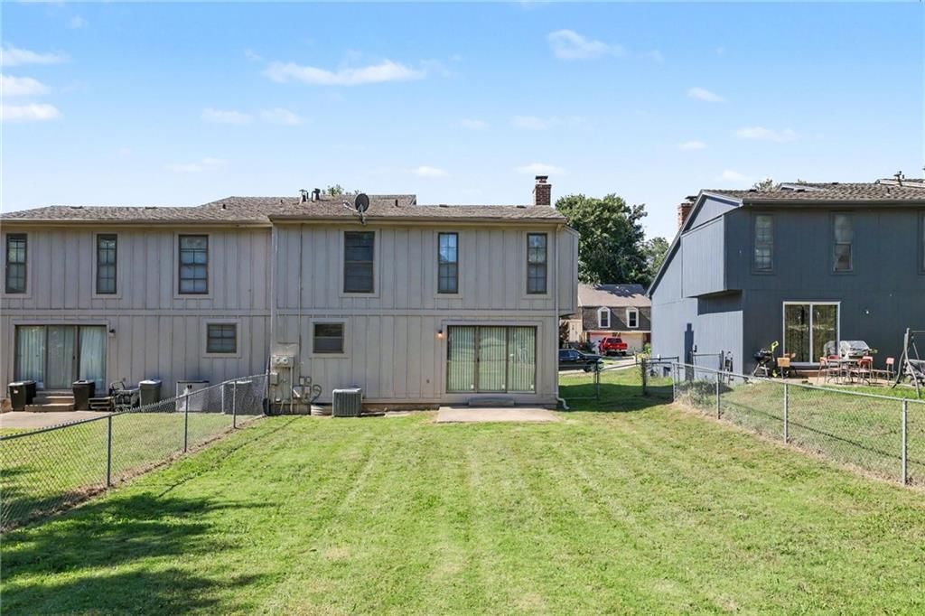 Fenced yard, mature trees and chain-link fence at 7507 Long Avenue, Lenexa, KS 66216