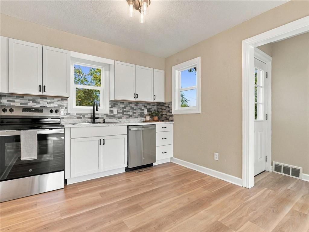 White kitchen, shaker cabinets and stainless steel appliances at 204 Westview Place, Excelsior Springs, MO 64024