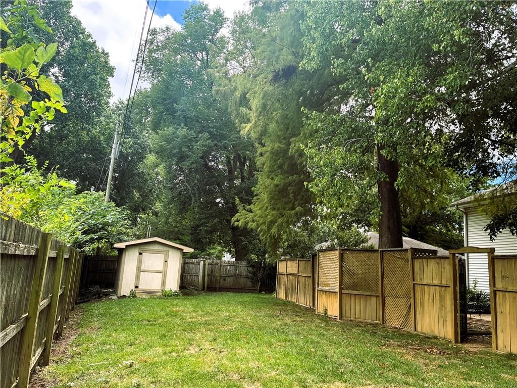 Fenced yard, mature trees and wood fence at 1212 SW Horizon Drive, Blue Springs, MO 64015