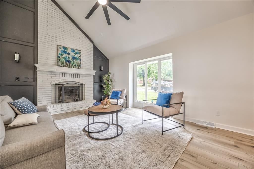 Tall ceilings, open floor plan and statement lighting at 1105 Brookside Place, Raymore, MO 64083