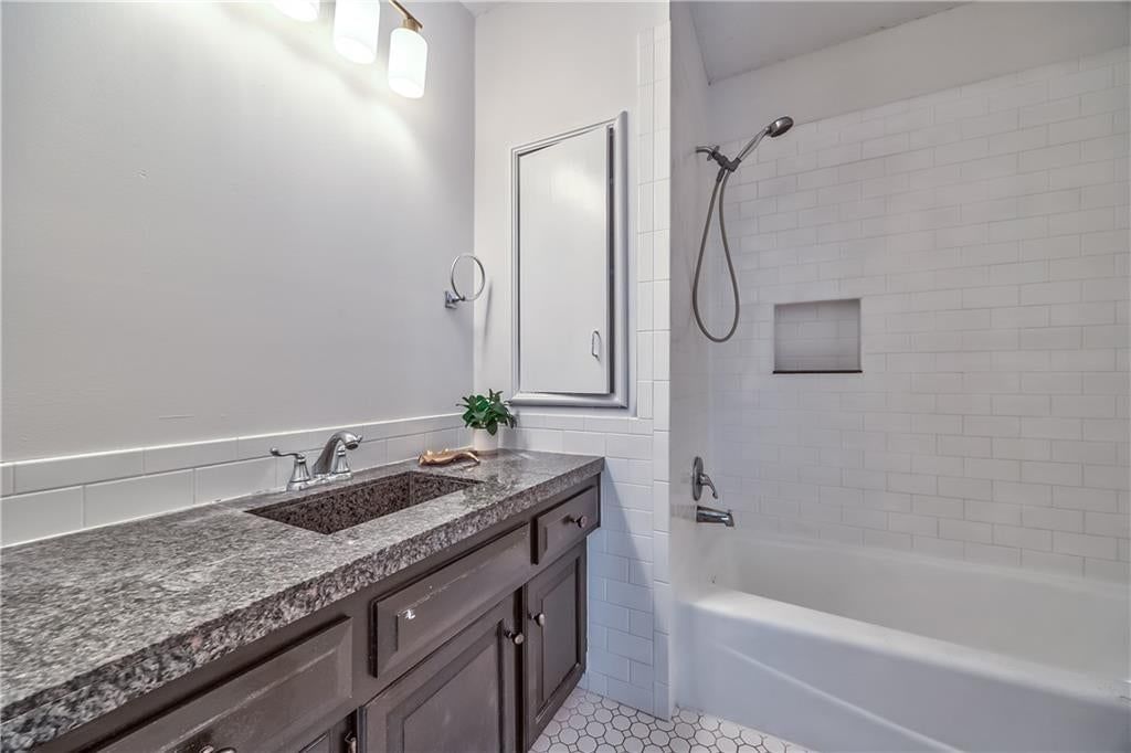 Tiled shower at 1105 Brookside Place, Raymore, MO 64083