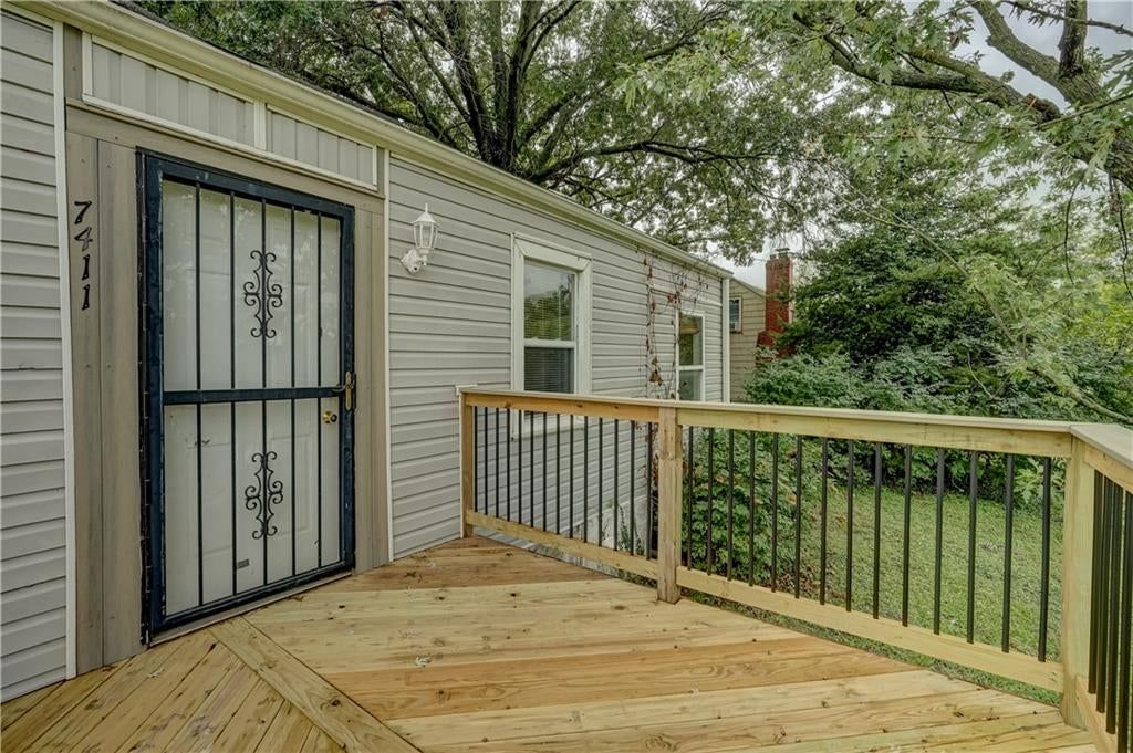 Covered front porch, black window frames and black hardware at 7411 E 83rd Street, Kansas City, MO 64138